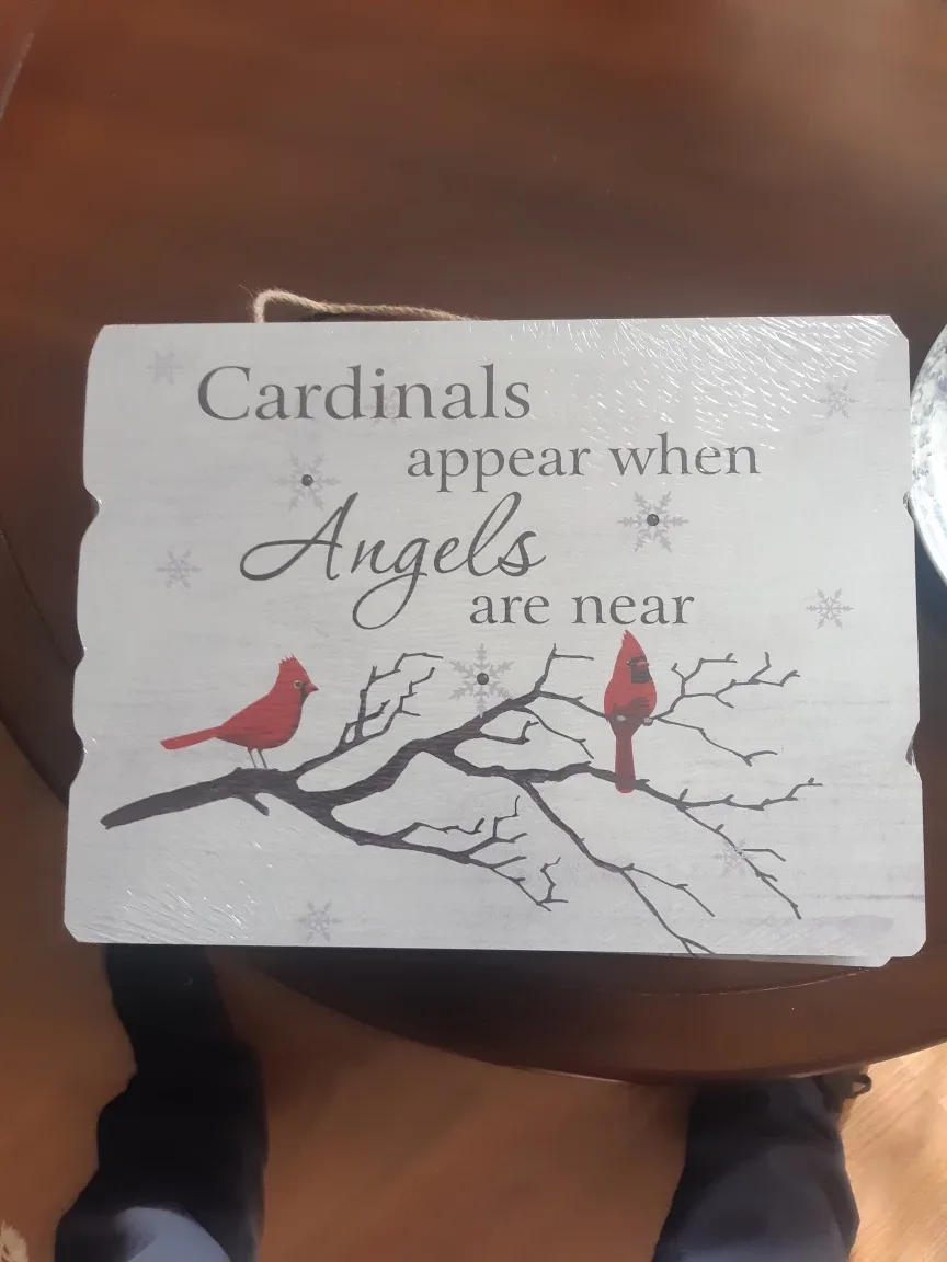 Cardinals appear when Angels are near wood sign
