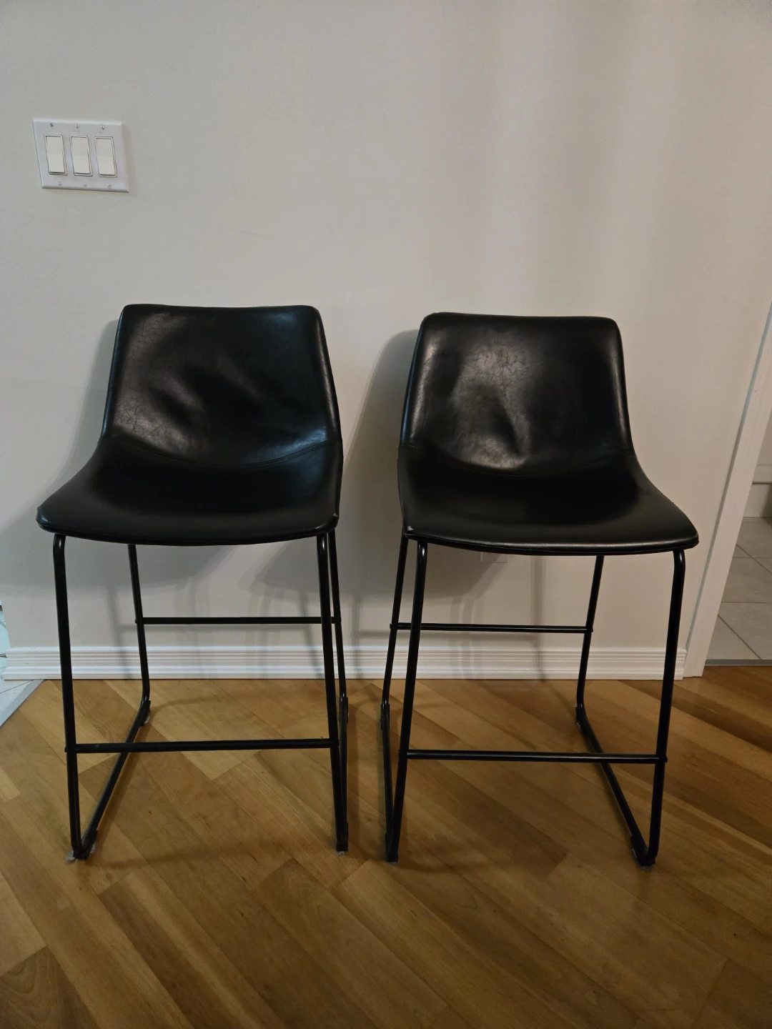 2 x Black leather stools for sale