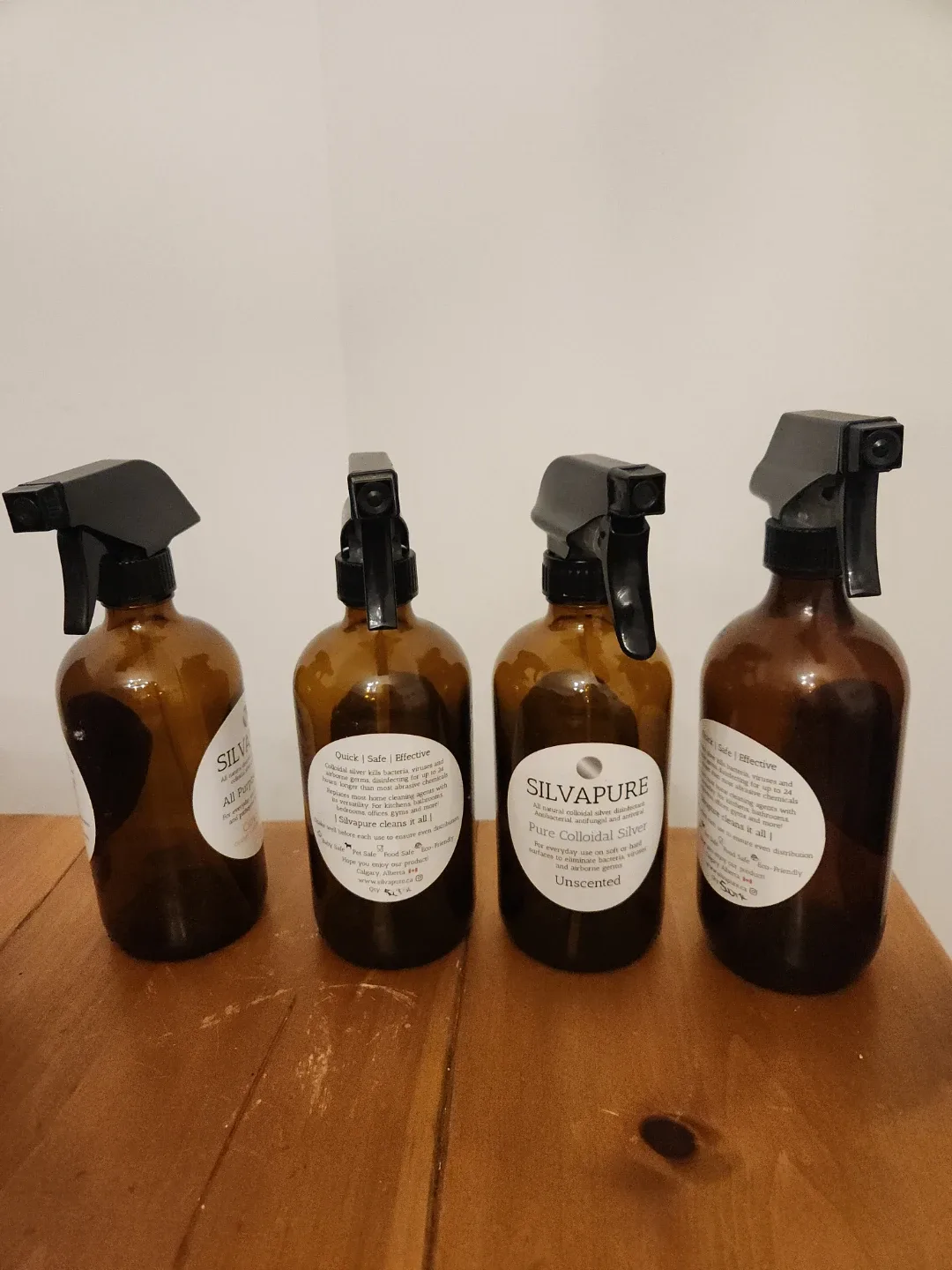 Four empty glass bottles with squirt querks