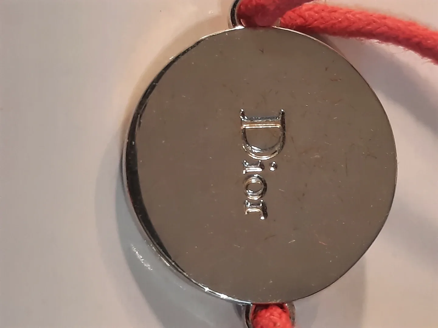 Cristian dior bracelet on red cord image indicator(3)