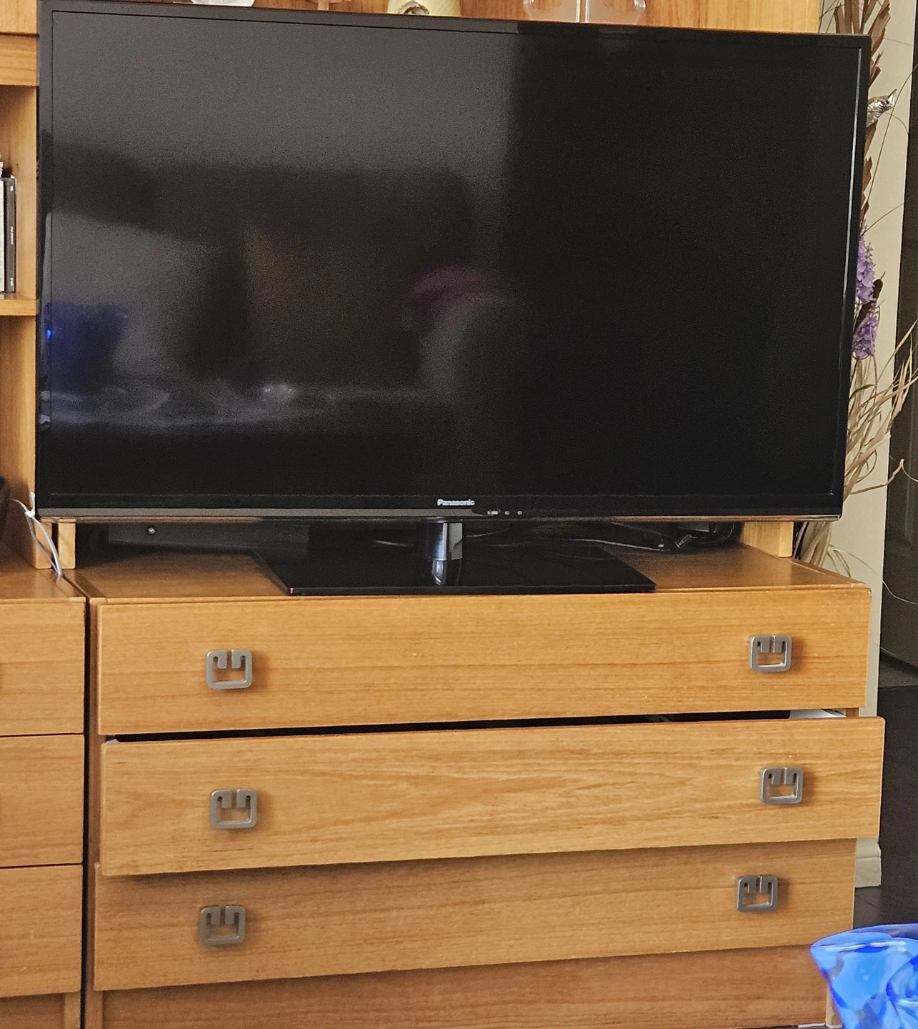 Panasonic TV , wireless headphones, a box with remote box