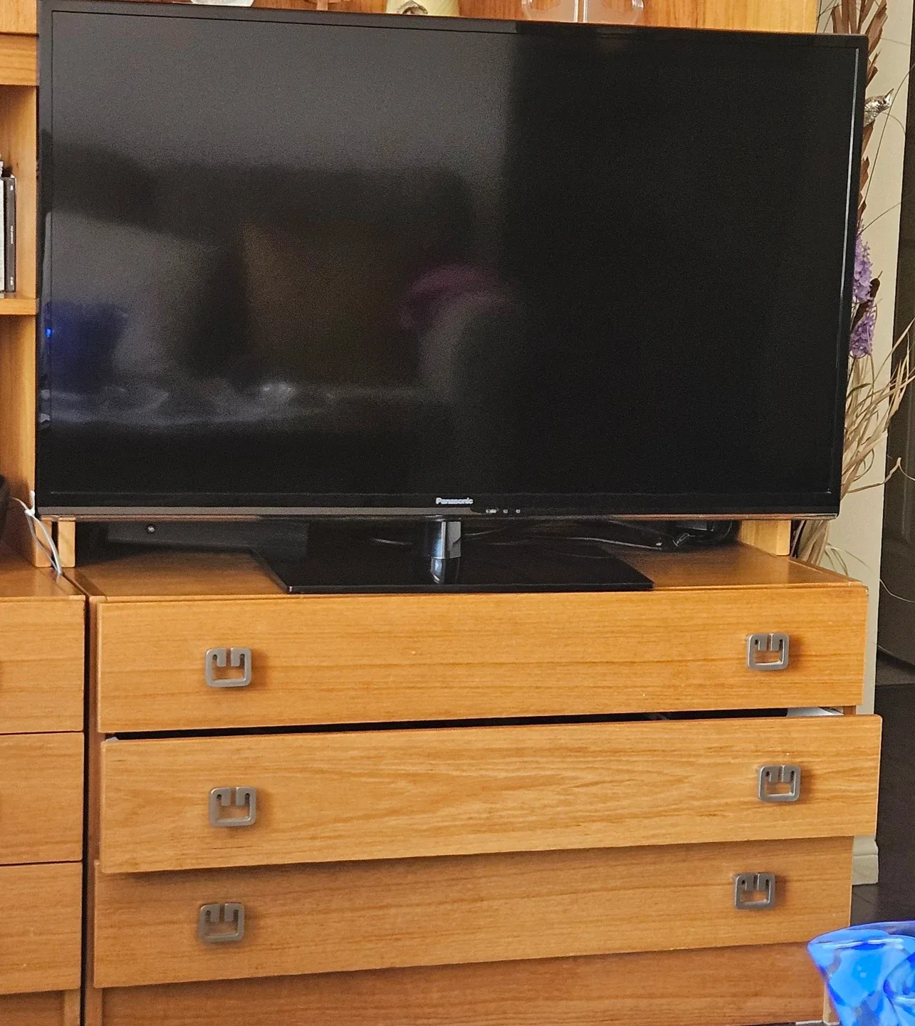 Panasonic TV , wireless headphones, a box with remote box