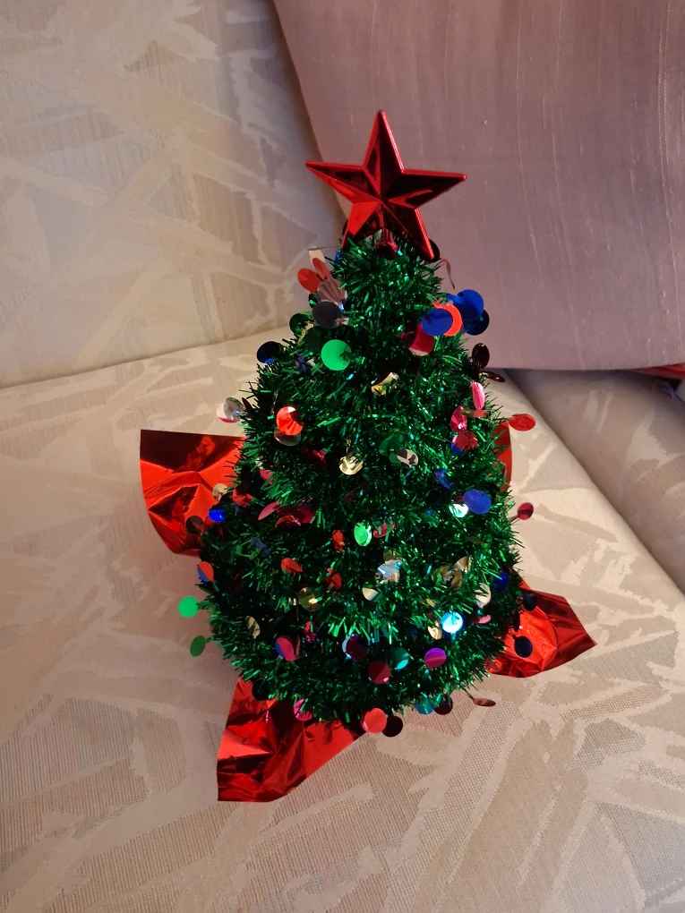 Tinsel tabletop Christmas tree with a star