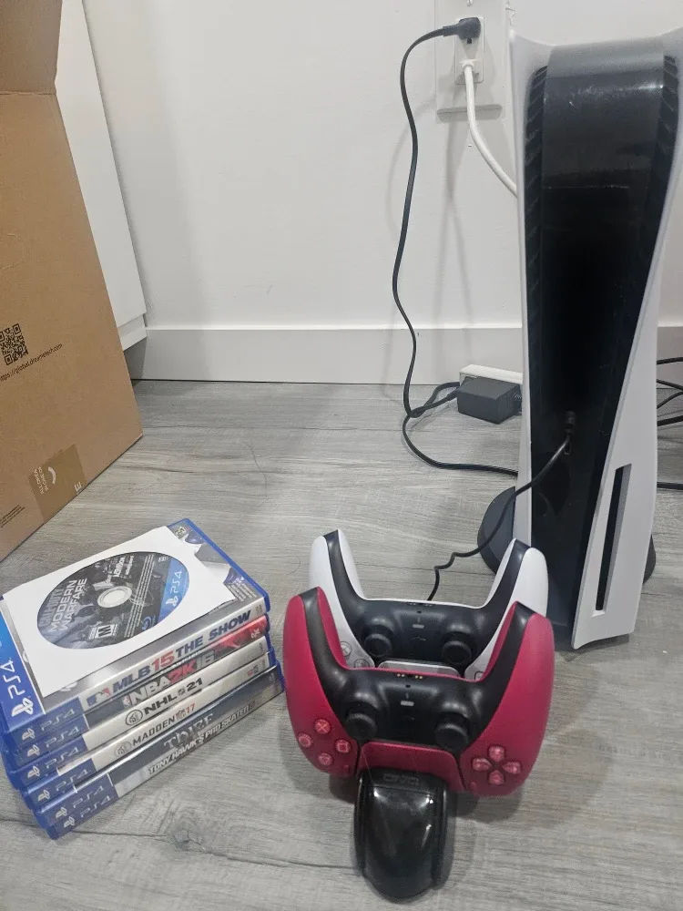 PS5 1TB console with 2 controllers + charger + 7 games