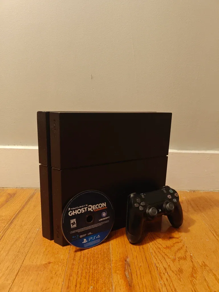 PS4 with a controller and GTA V, and 2 Tom Clancy games