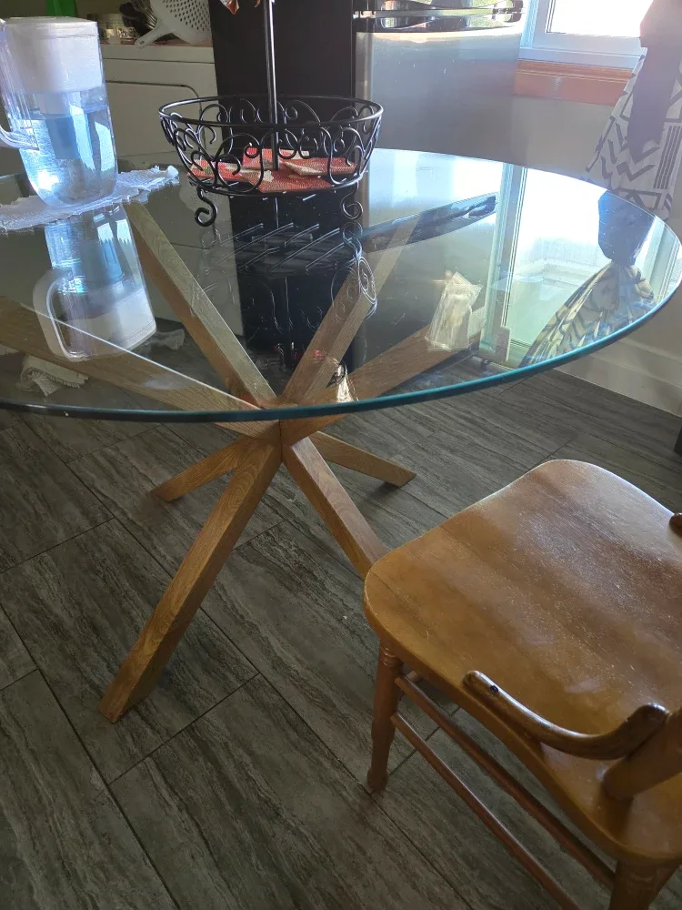 Glass table with a metal base inspired by wood.