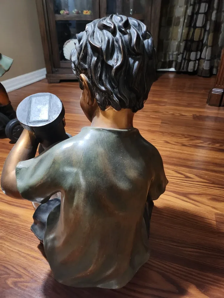 Boy holding a frog statue image indicator(3)