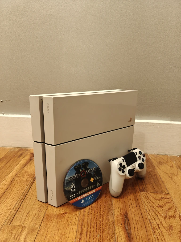 PS4 white with a controller and games