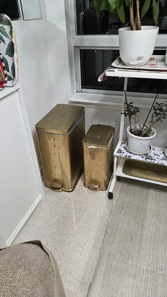 4 gold spray painted stainless steel trash cans