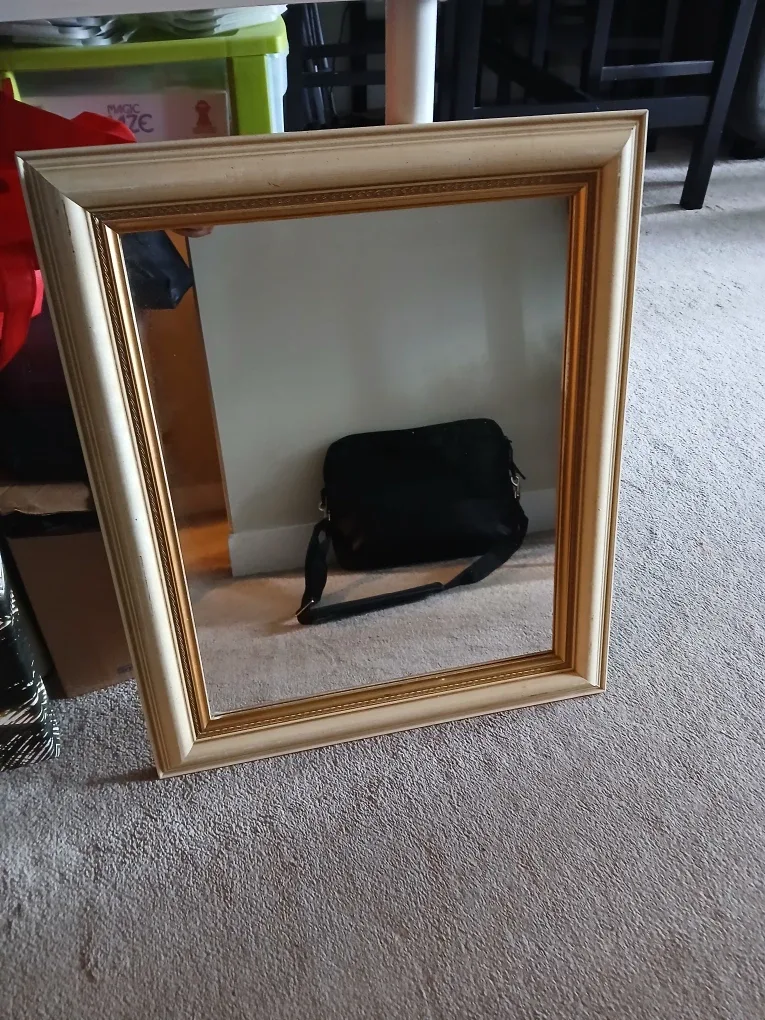 Cream and gold coloured framed mirror