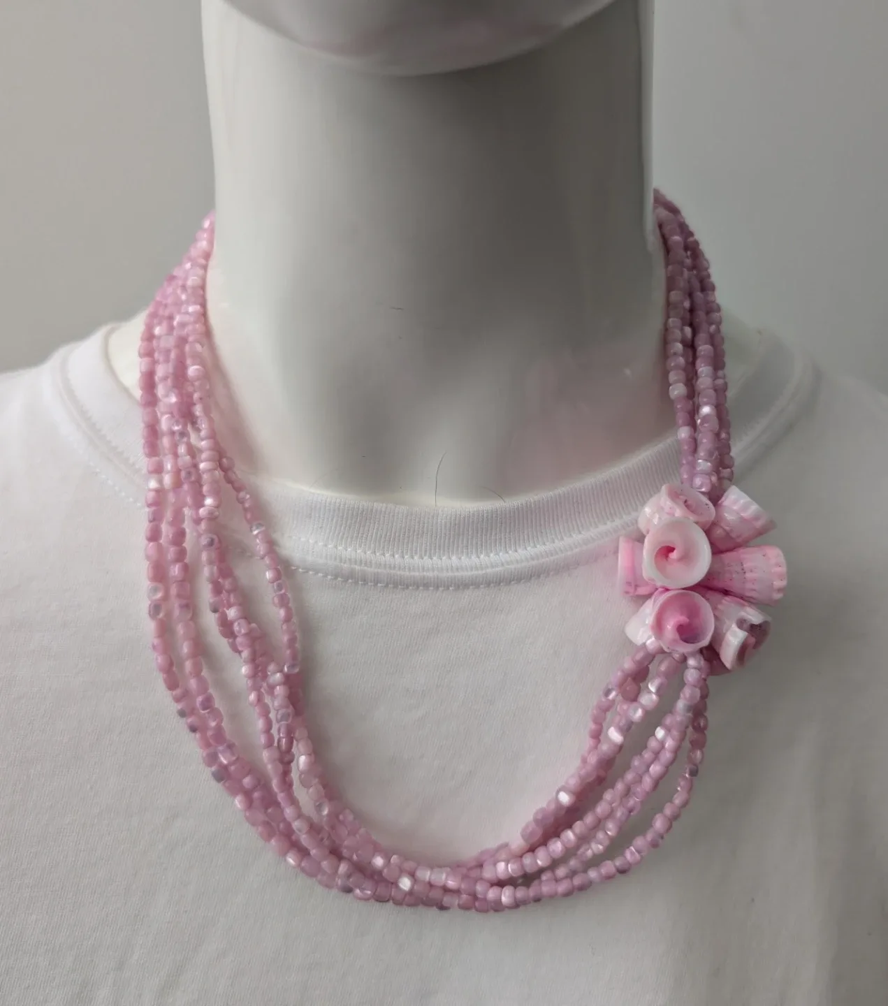 Pink necklace 6 strands of glass beads with shell cluster