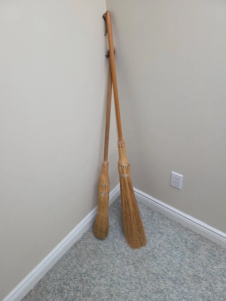 Two hand made corn brooms