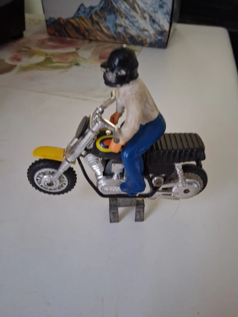 Vintage rider on Turb-O-Duster motorcycle with a stand
