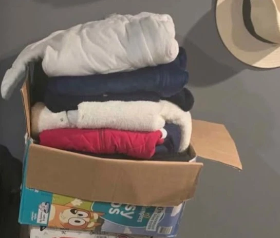Box of baby snow suits