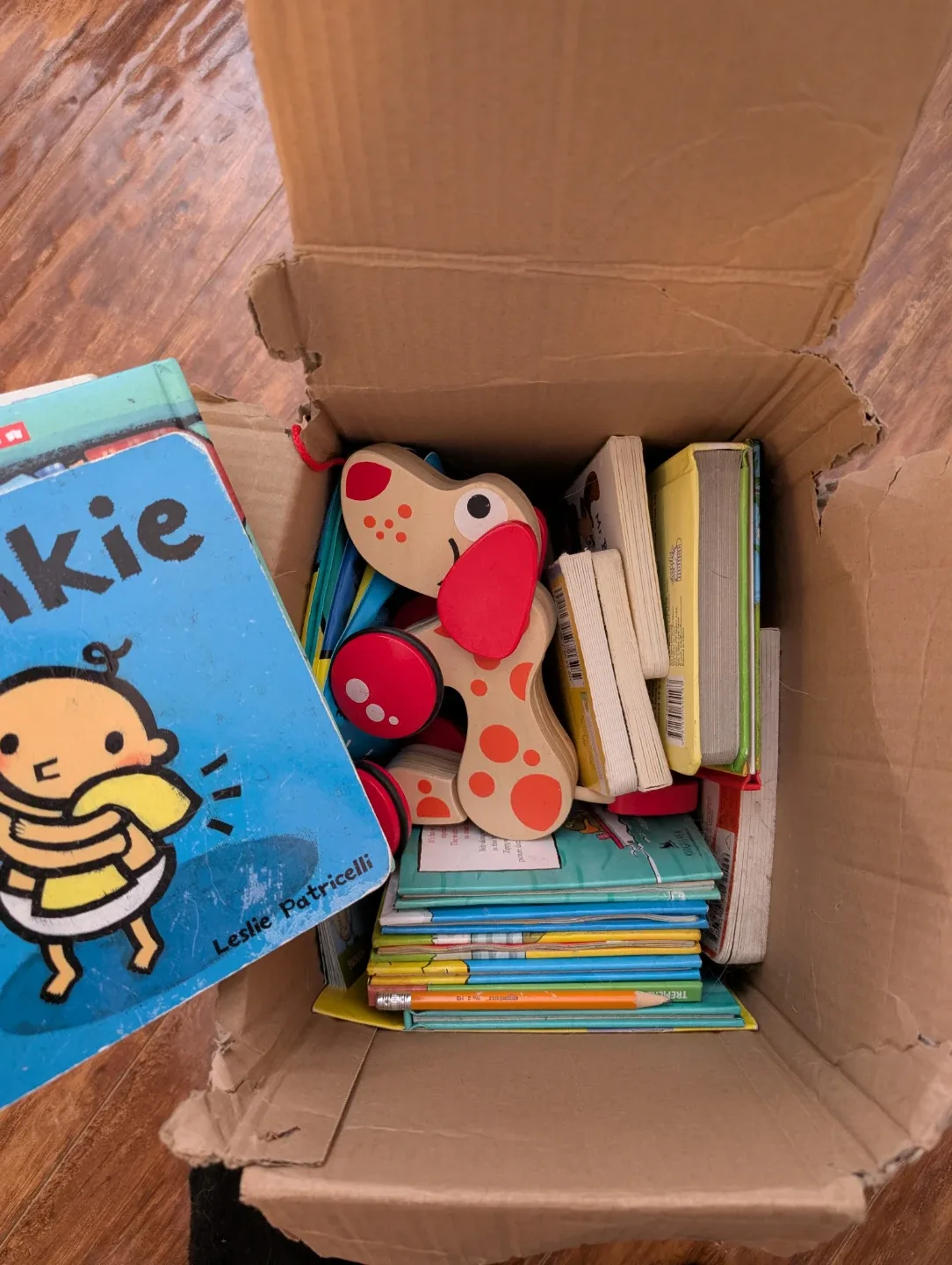 Box of Baby Books & Wooden Dog Toy