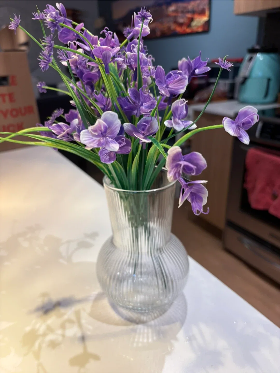 Purple Artificial Flowers in Glass Vase