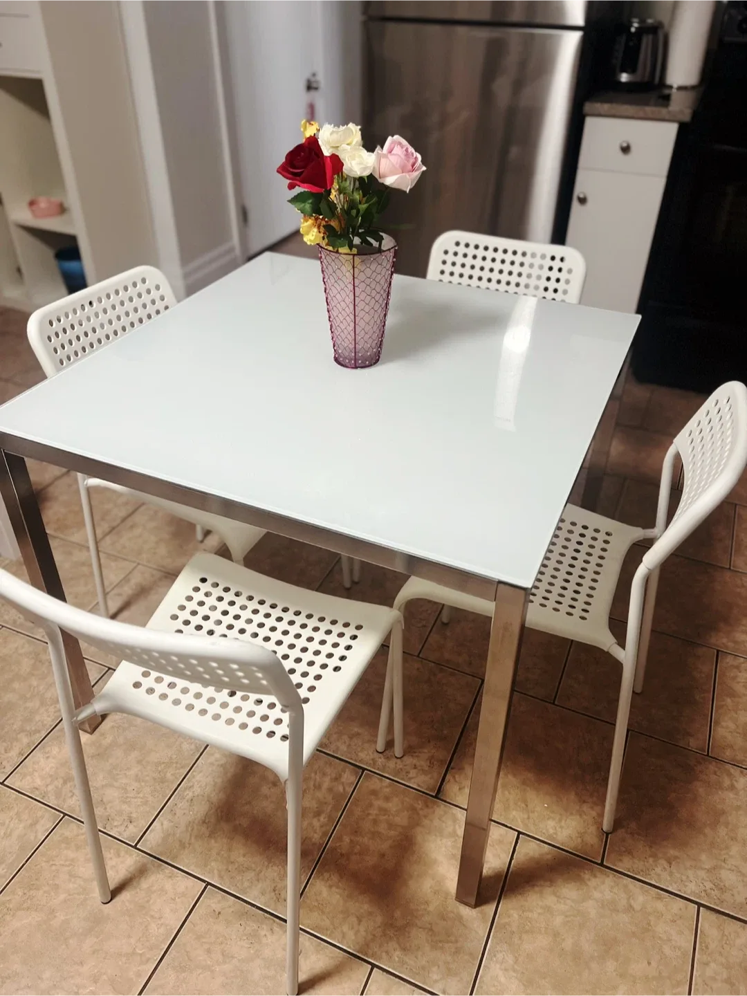 Ikea square dining table with four chairs,delivery available