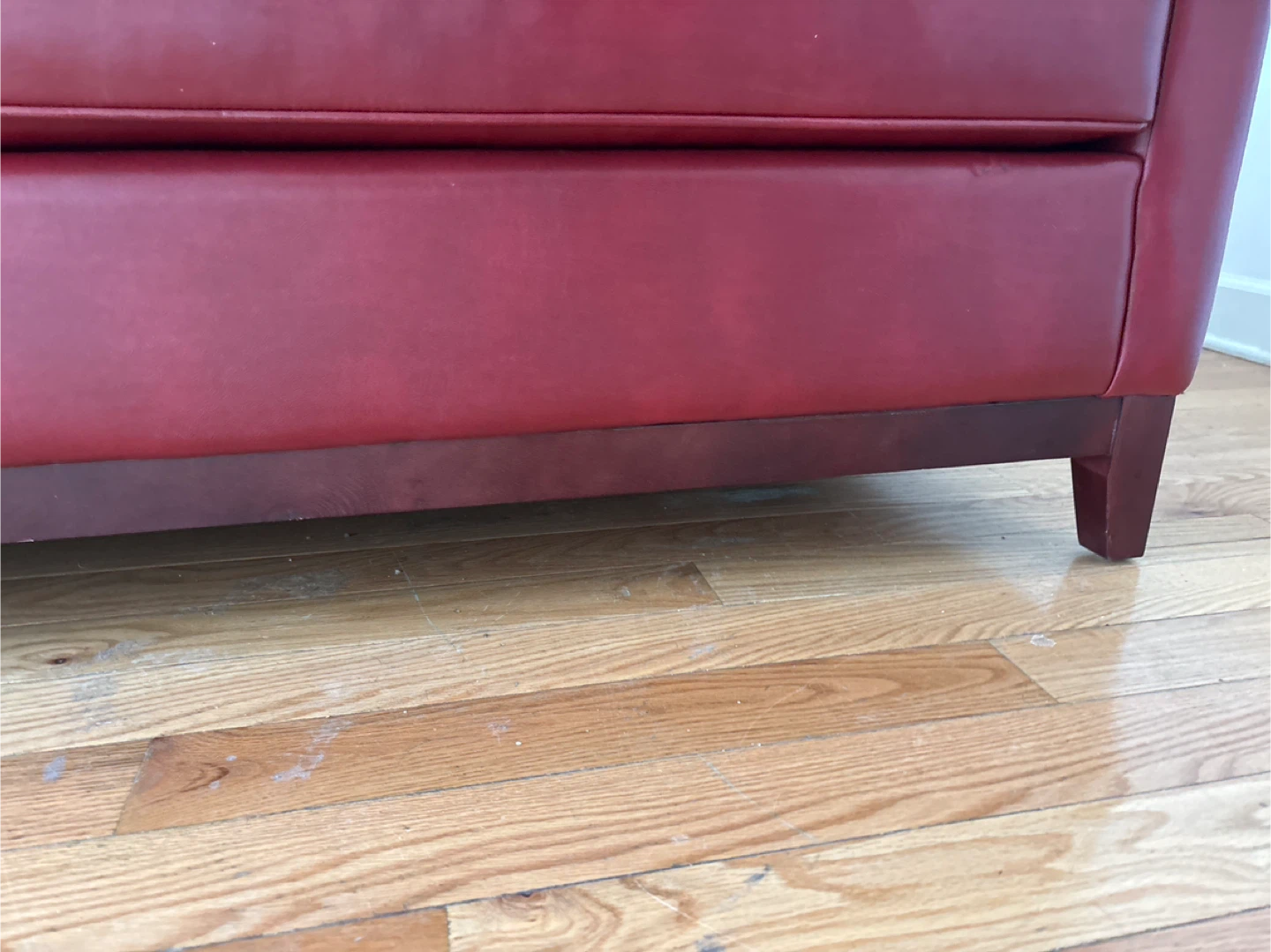 Small red leather couch . Has a wood frame . - photo 5