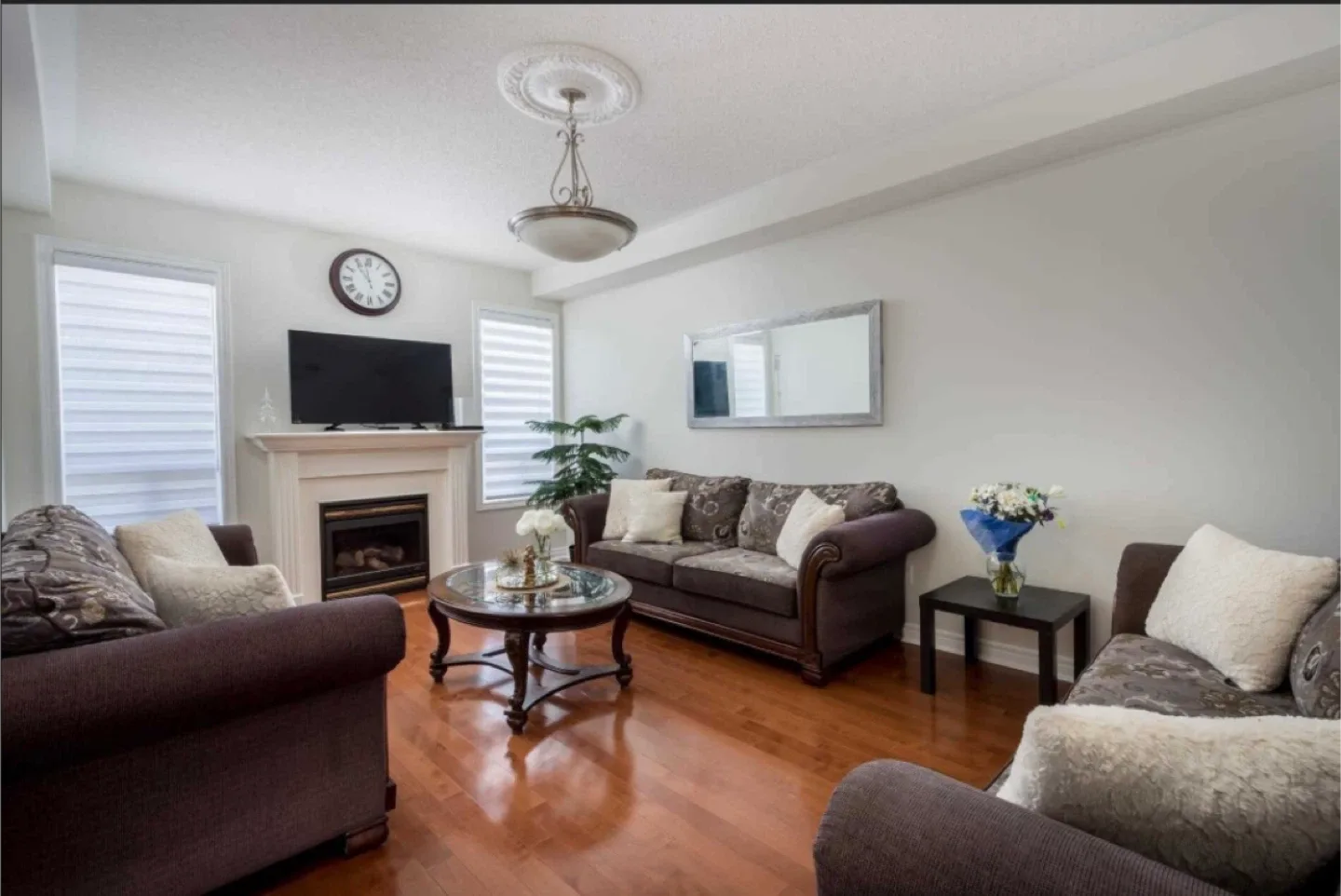3 Brown Couches and Oval Glass Top Coffee Table