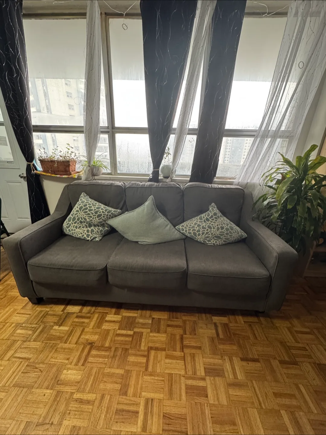 Comfortable Grey Three-Seater Sofa with pillows