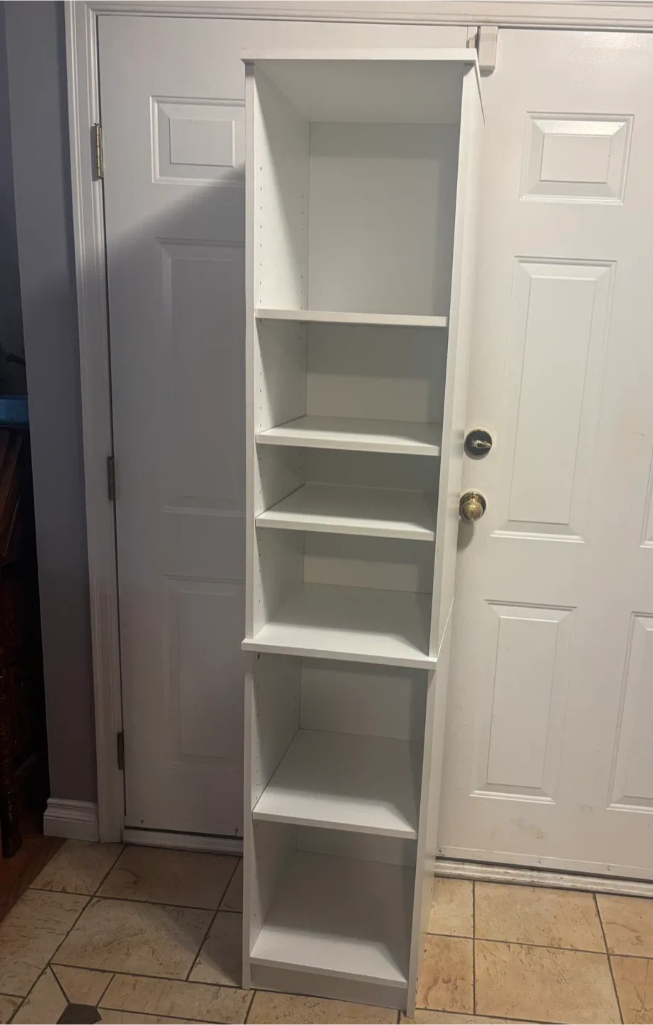 Tall white adjustable shelving unit