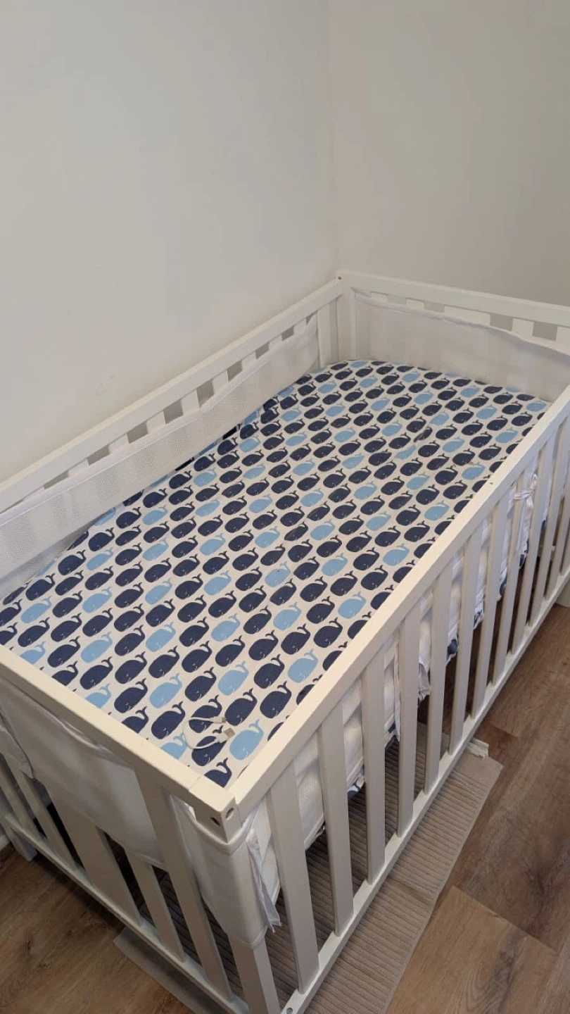 White Baby Crib with Whale Print Sheet