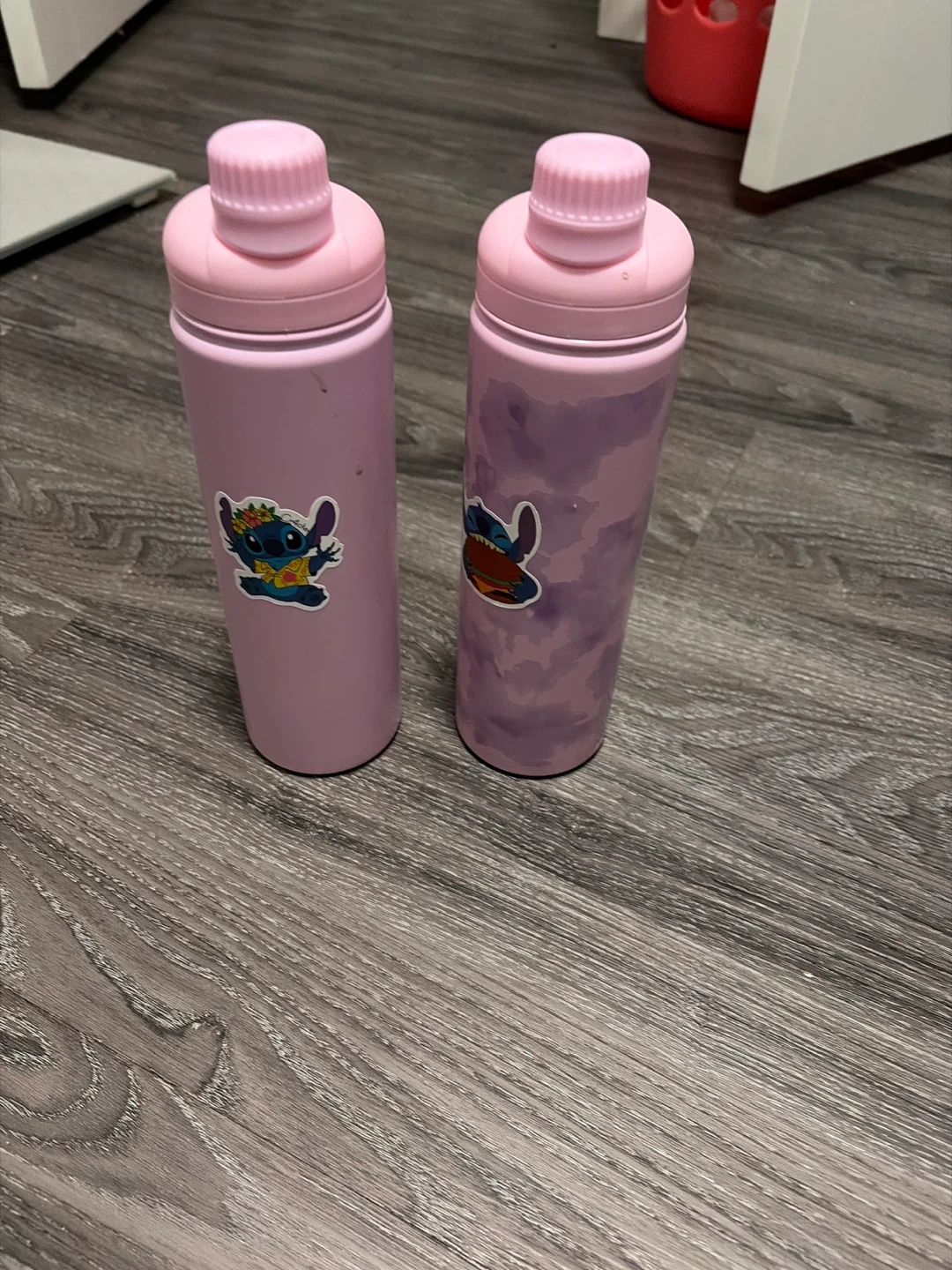 Two Pink Water Bottles with Stitch Stickers