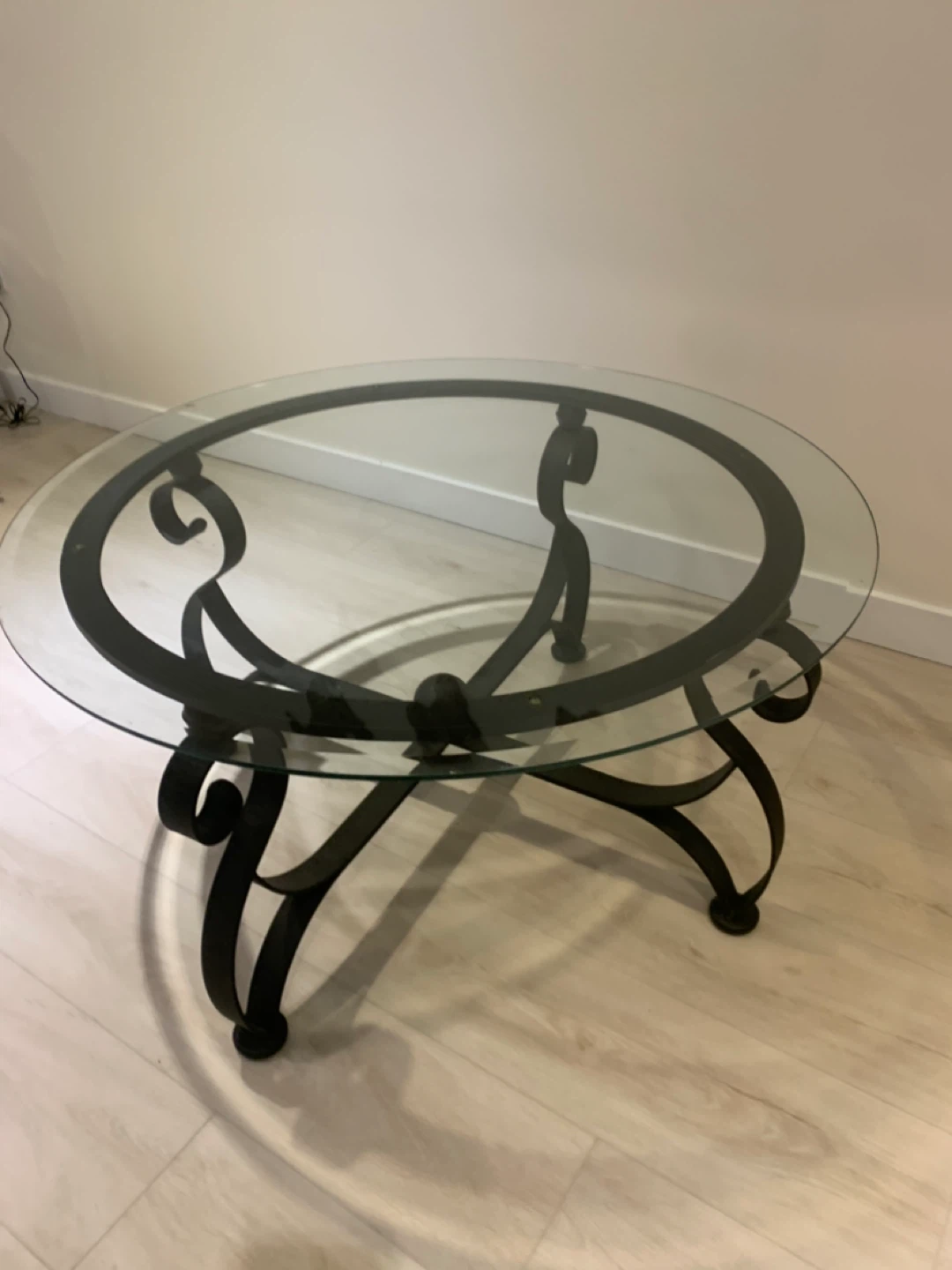 Glass top coffee table, black metal frame