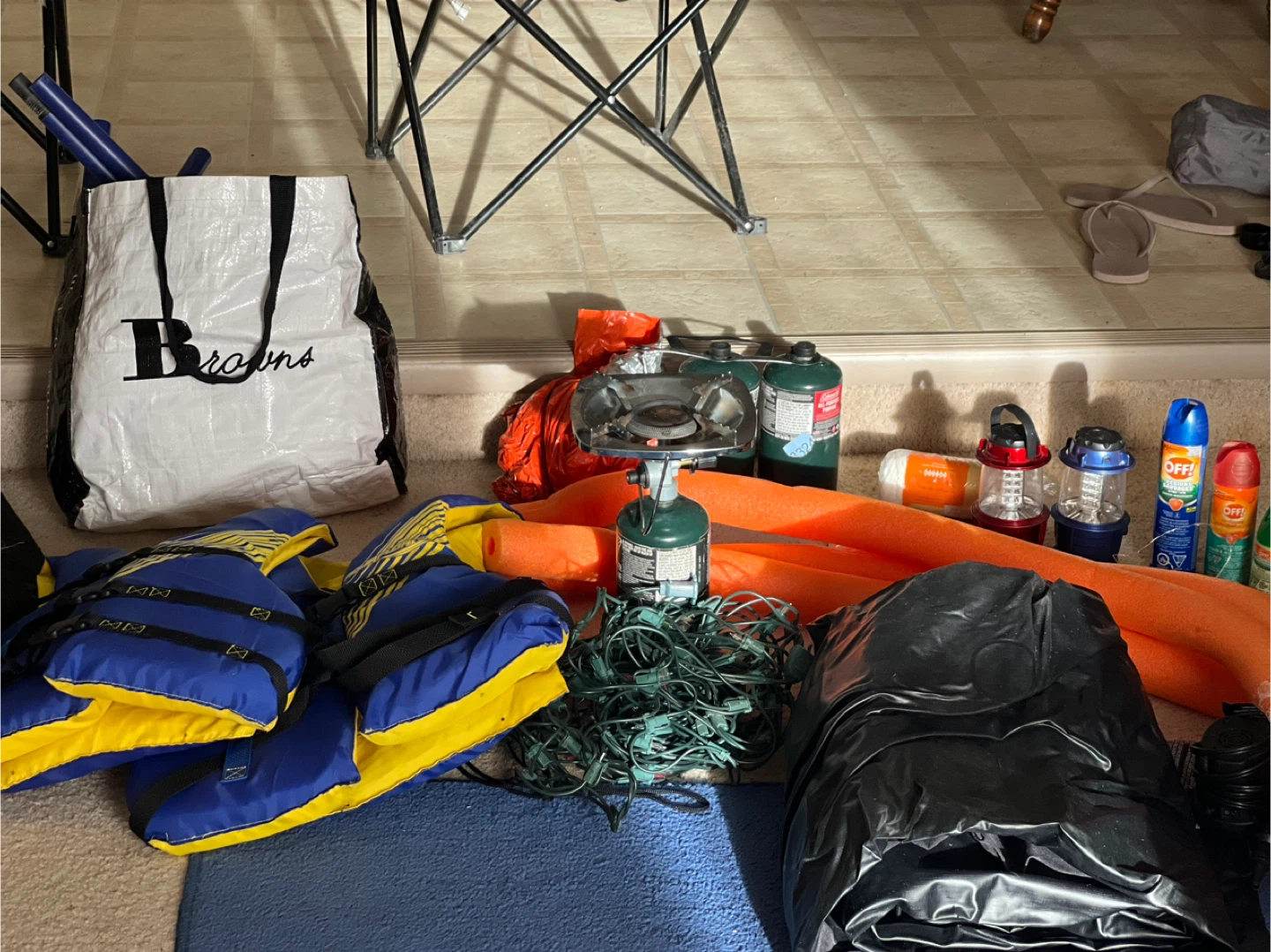 Camping gear: stove, life jackets, lanterns, bug spray