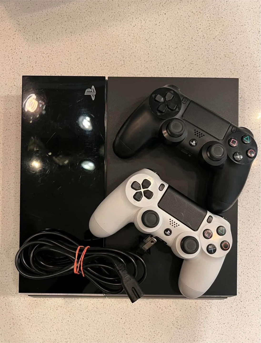 PS4 with 2 dual shock controllers (white and black)