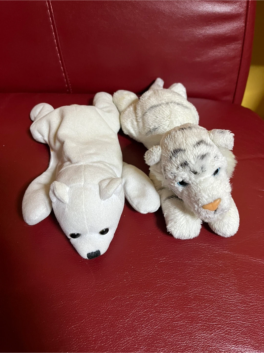 2 white plush toys, polar bear and tiger