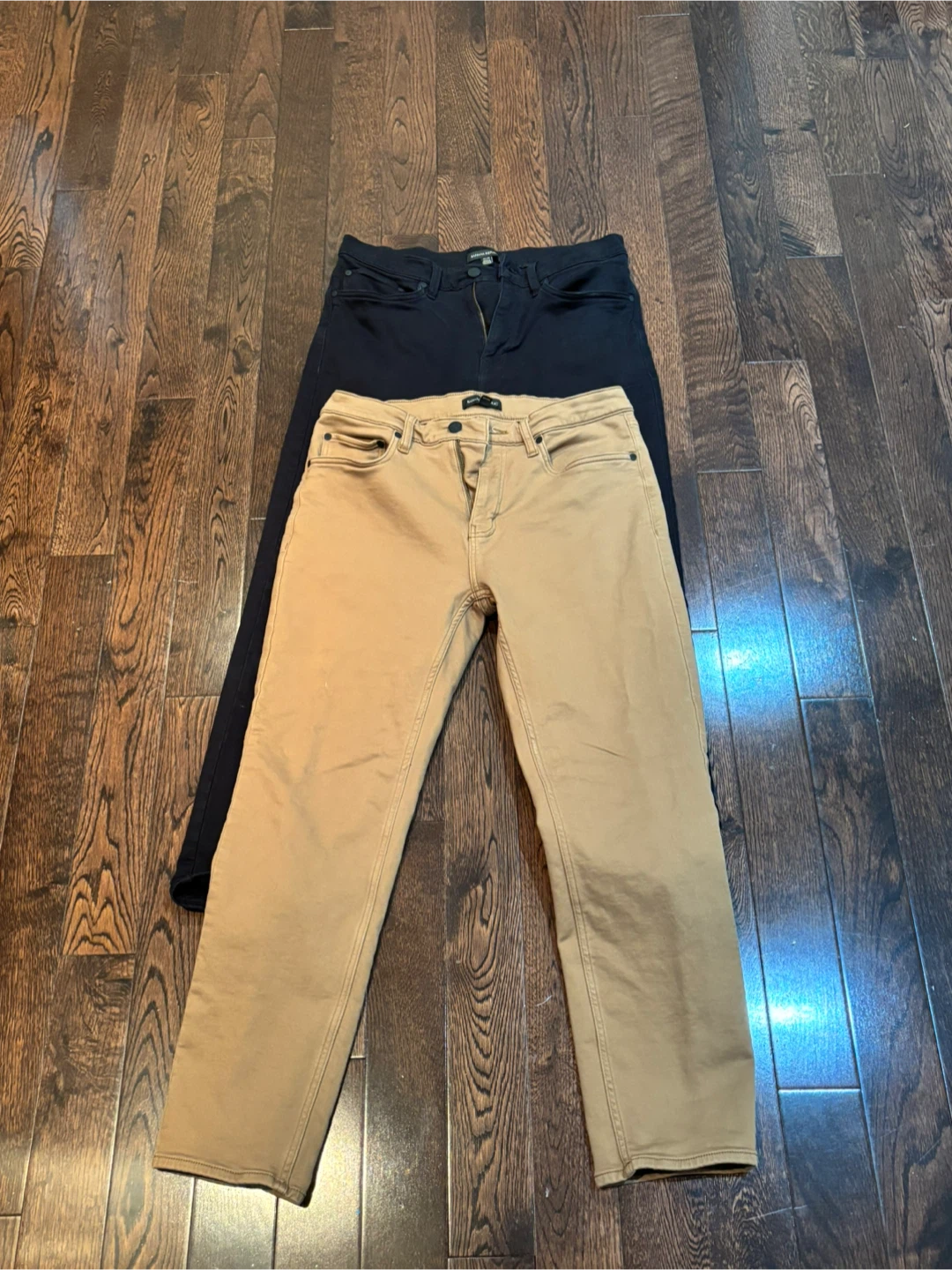 Two pairs of men's jeans, black and tan