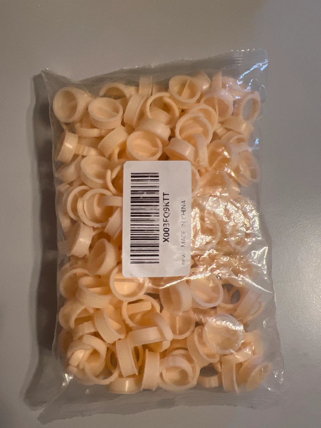 Bag of Small Beige Plastic glue Rings