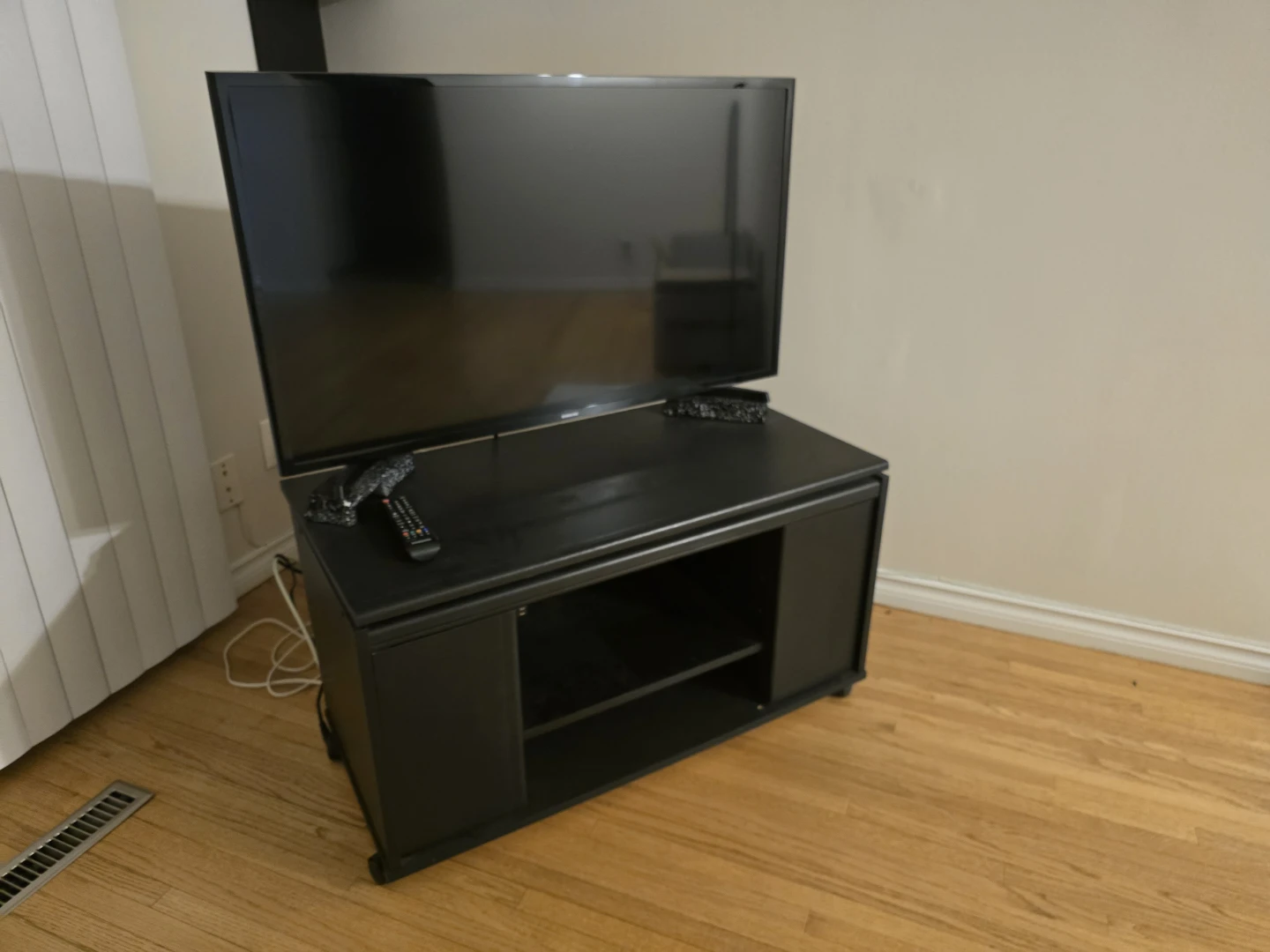 Samsung TV and Black TV Stand