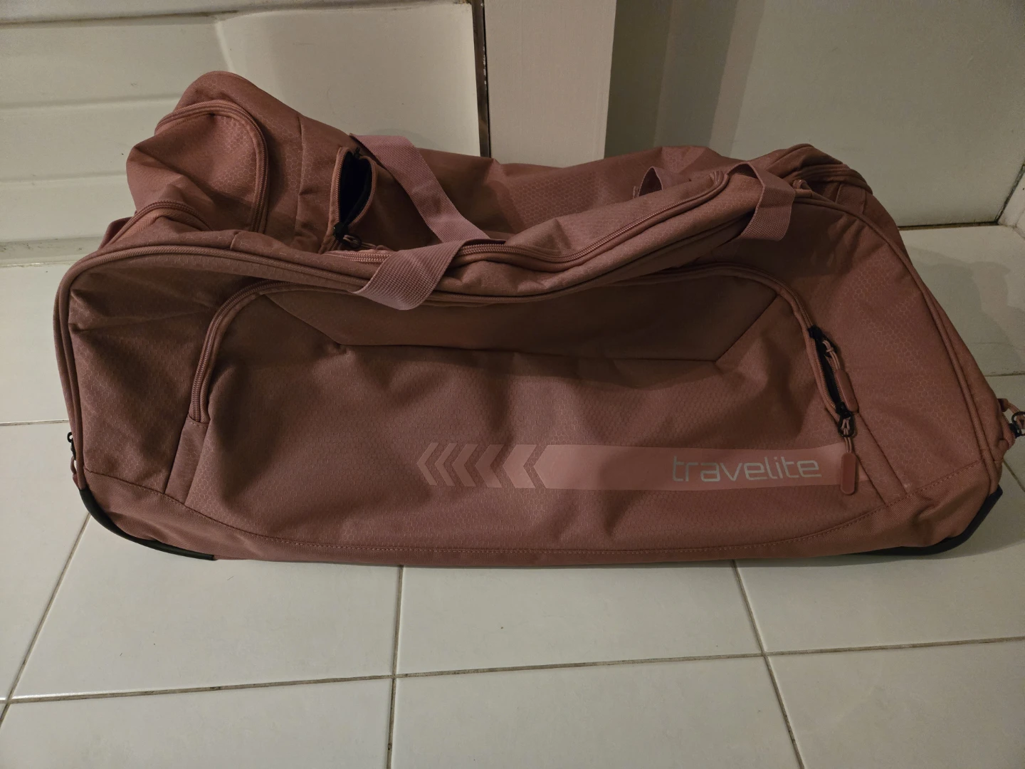 Brand new pink check in bag with wheels