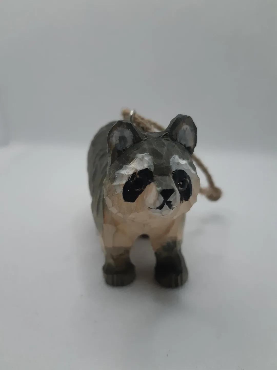 Hand-carved wooden raccoon ornament