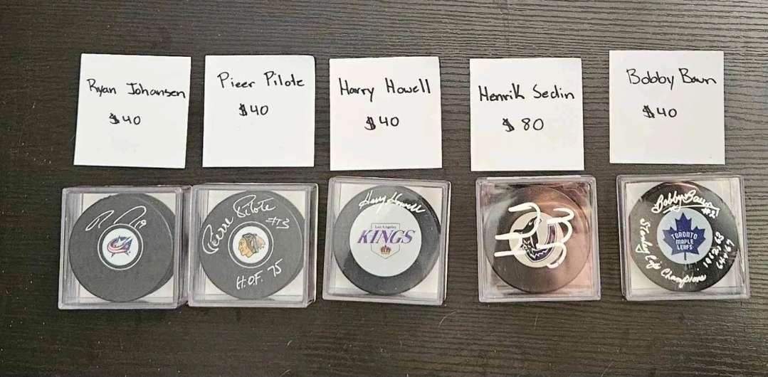 Signed Hockey Pucks - Johansen, Pilote, Howell, Sedin, Baun