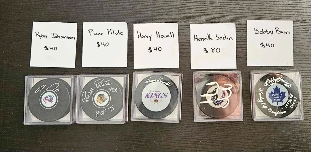Signed Hockey Pucks - Johansen, Pilote, Howell, Sedin, Baun