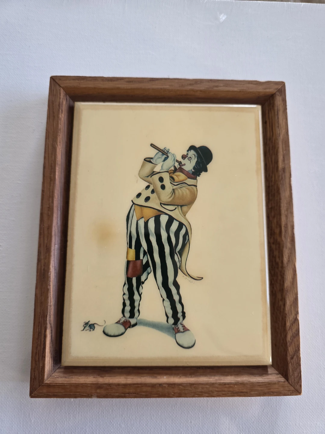 Clown on ceramic tile framed