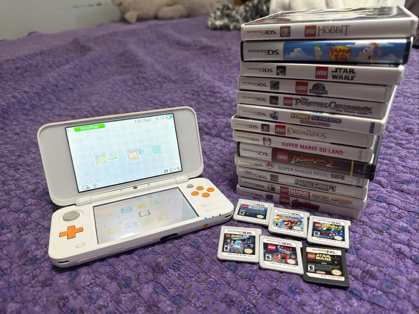 New Nintendo 2DS XL, 19 games, case, charger and more
