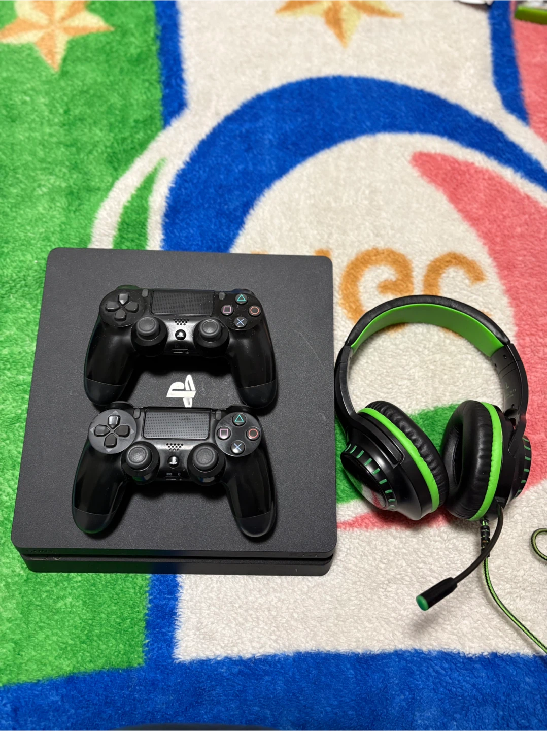 PlayStation 4 Slim with 2 Controllers and a headset.