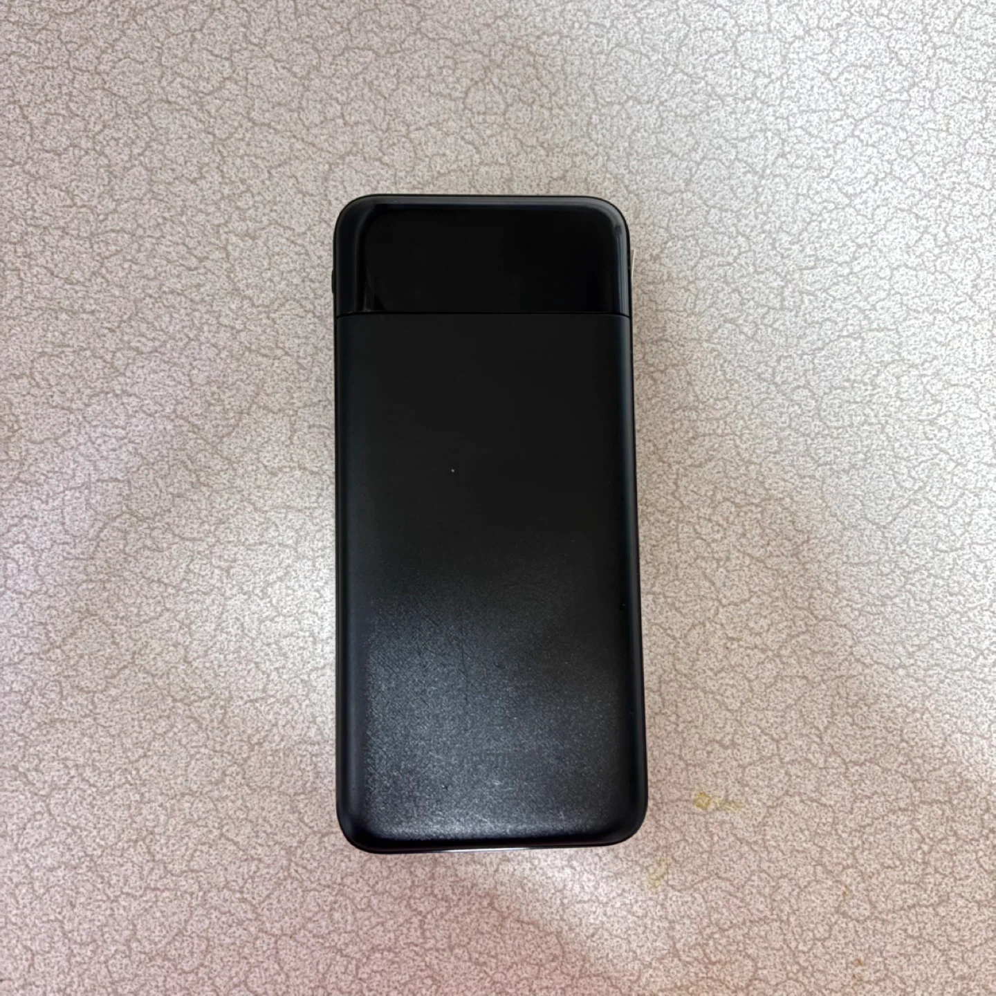 Black portable power bank with charging cables