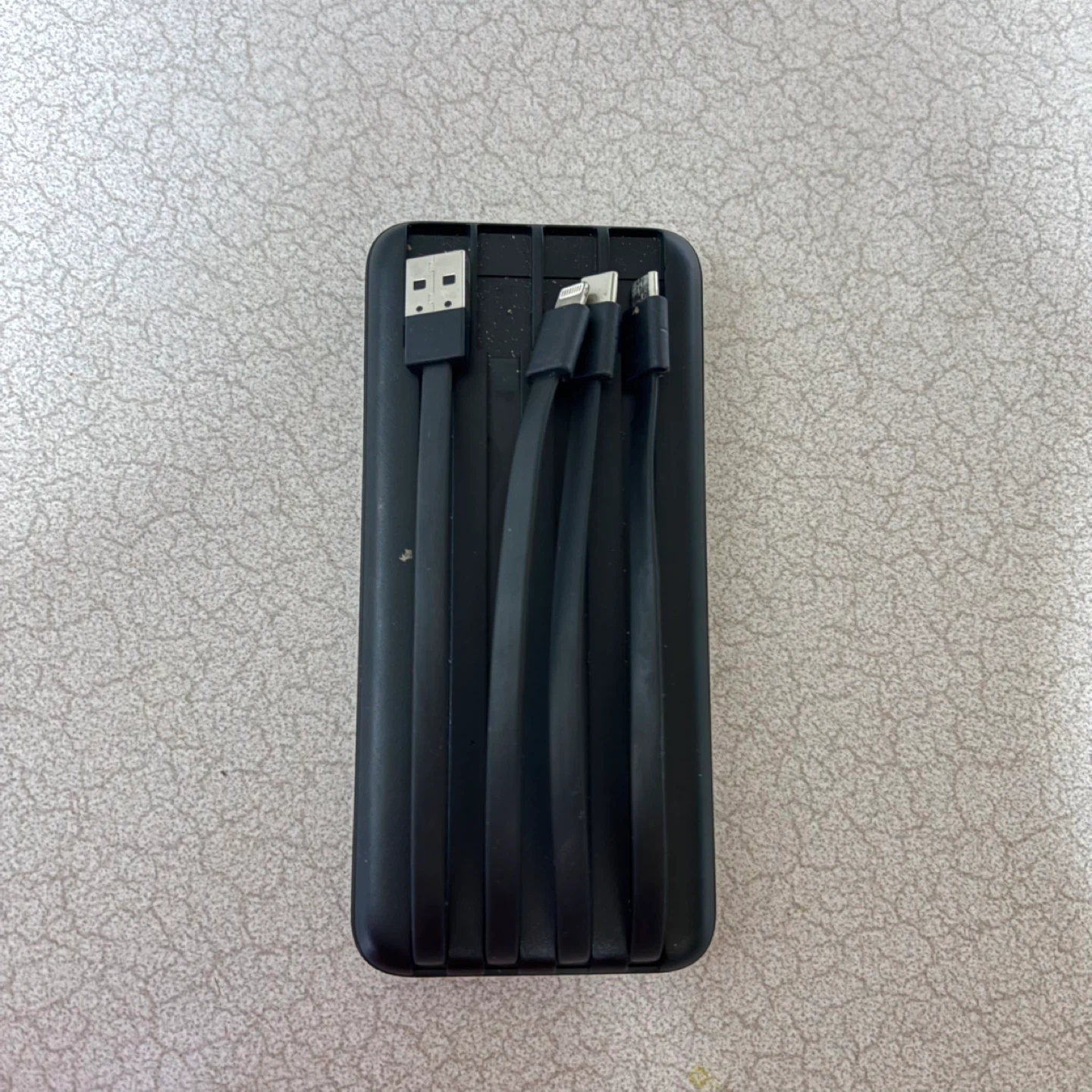 Black portable power bank with charging cables - photo 2