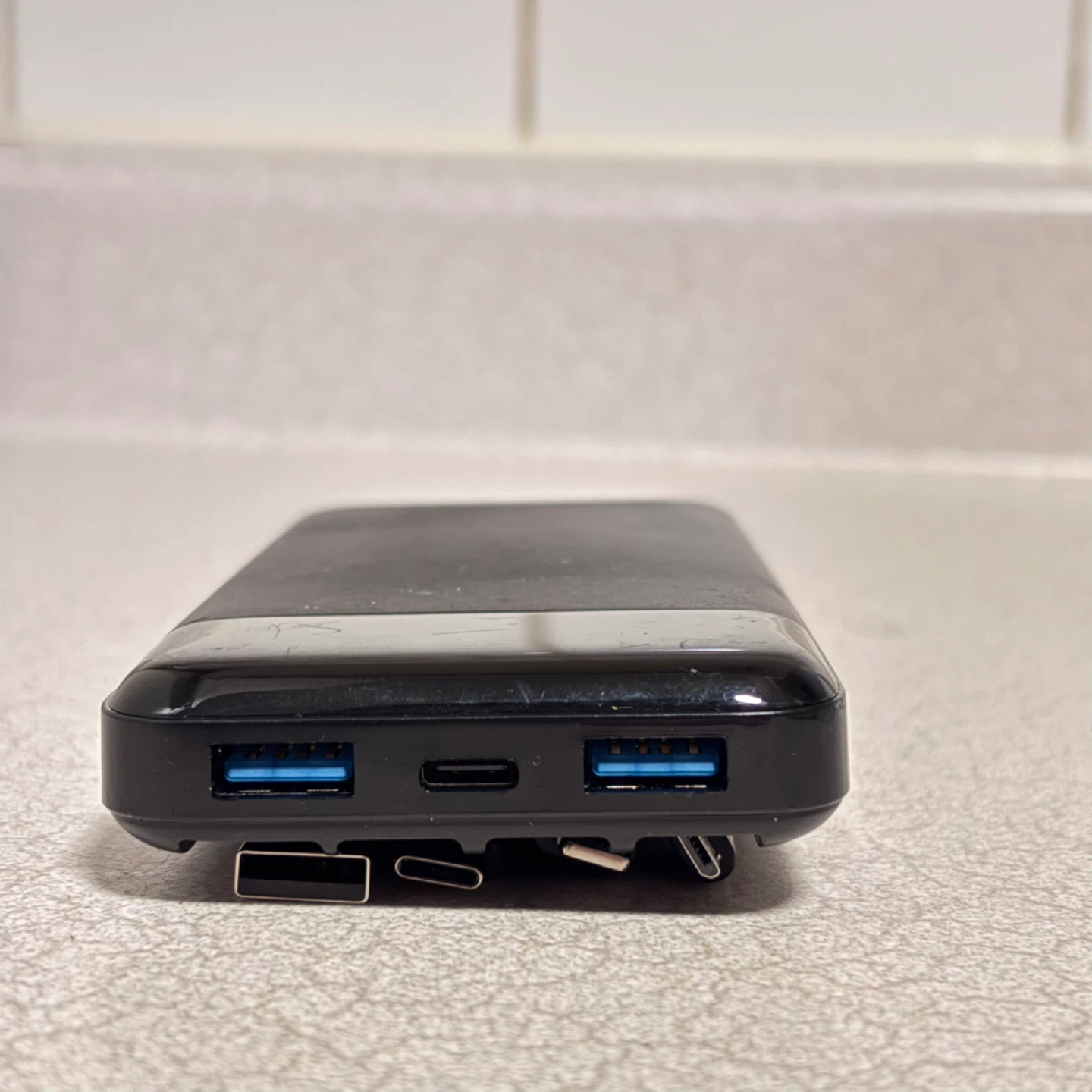 Black portable power bank with charging cables - photo 3