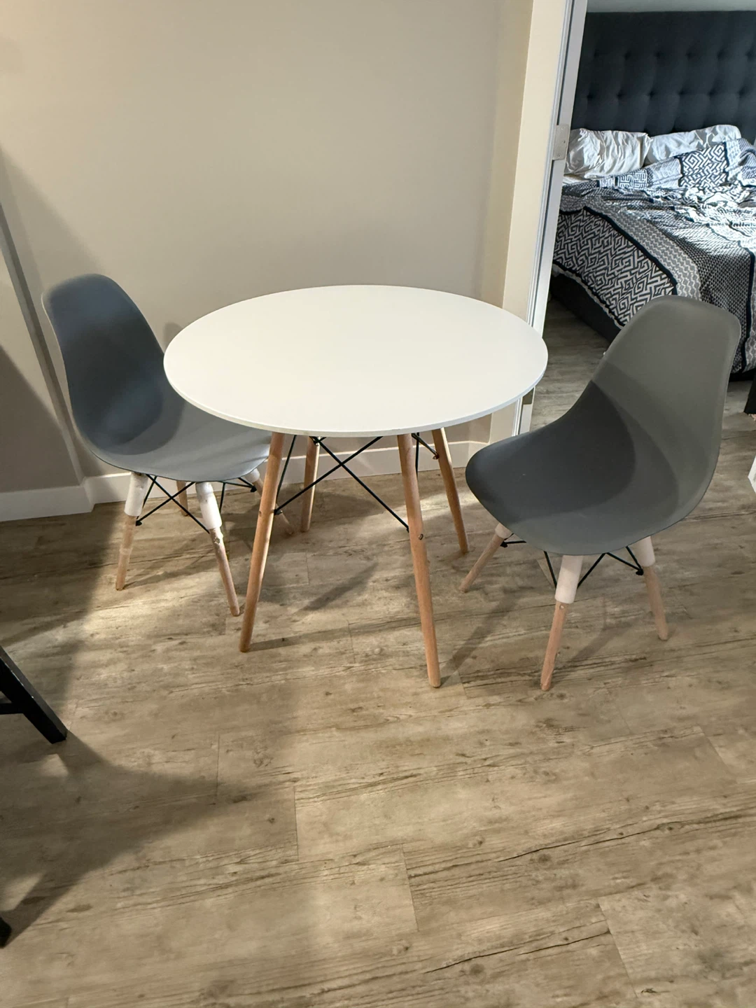 Round White Dining Table with Four Grey Chairs