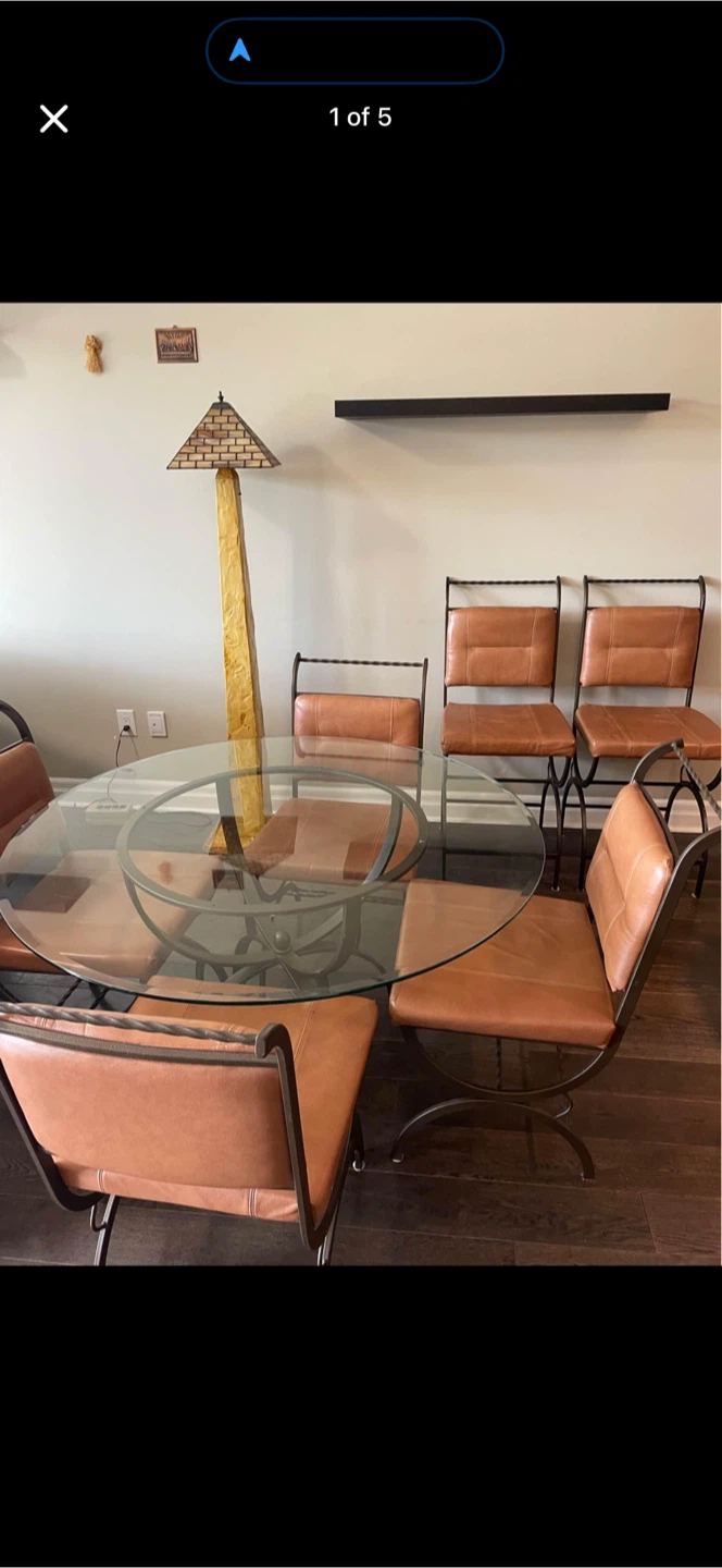 A metal, glass and genuine leather dinette set.