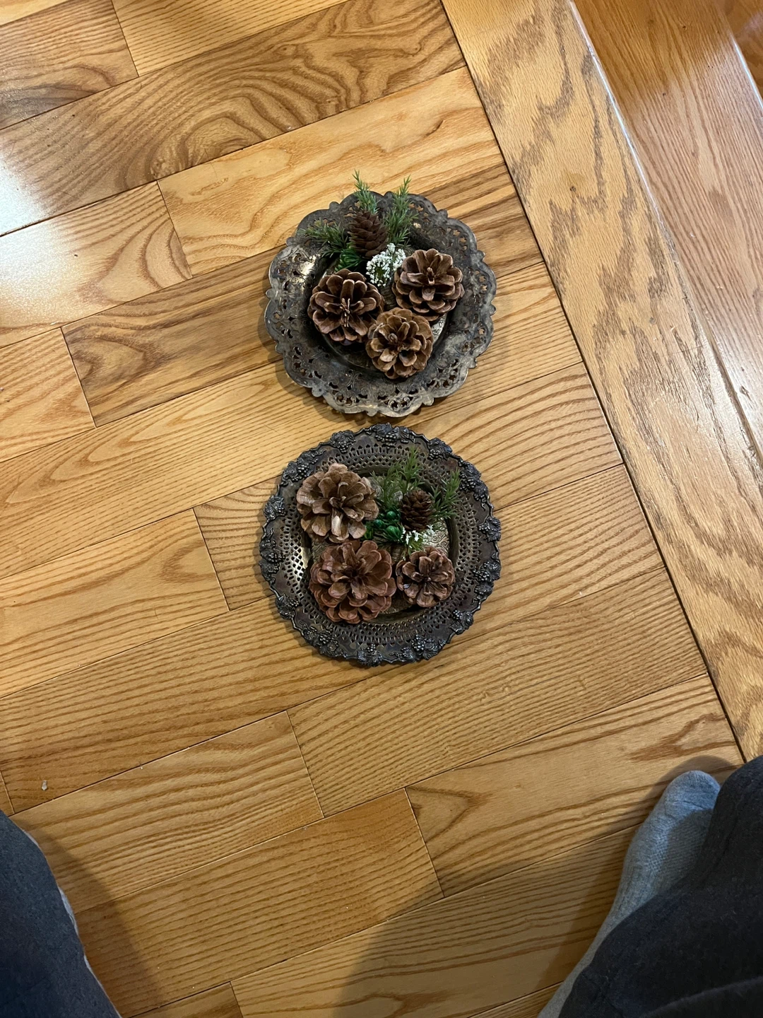 A set of decorative silver-plated dishes with pine cones