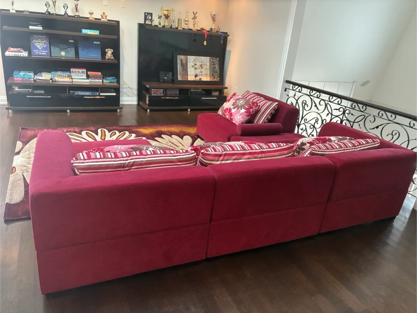 Red Sectional Sofa with Pillows, rug and shelves