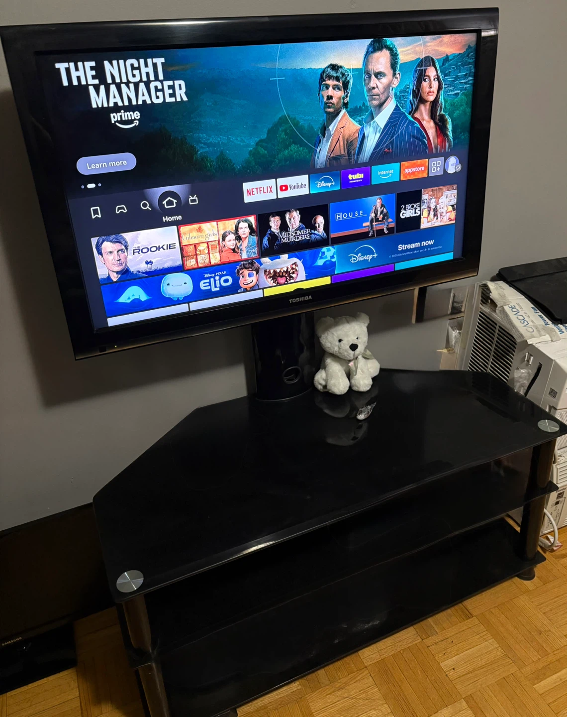 Toshiba TV, Black Glass TV Stand, and Amazon Firestick