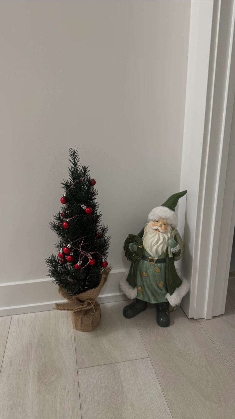 Small pre-lit Christmas tree with red ornaments